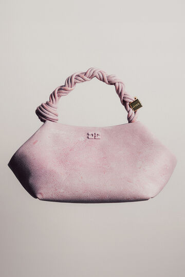 Product display photo of the GANNI Bou Bag in a light pink textured fabric featuring a twisted rope handle against a minimalist background