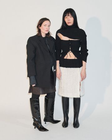 Future Talent Fabrics by A. Roege Hove: Models displaying sheer, layered black and cream knitwear garments