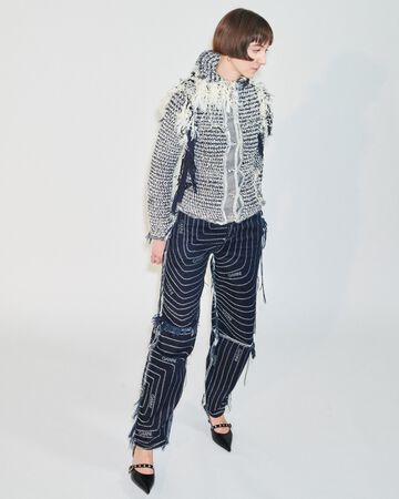 Future Talent Fabrics by Sarah Brunnhuber: Sarah posing in a white and grey patterned woven jacket with matching loose trousers