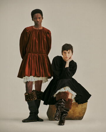 Two models wearing a brown and black dress from the Fall/Winter 2026 collection