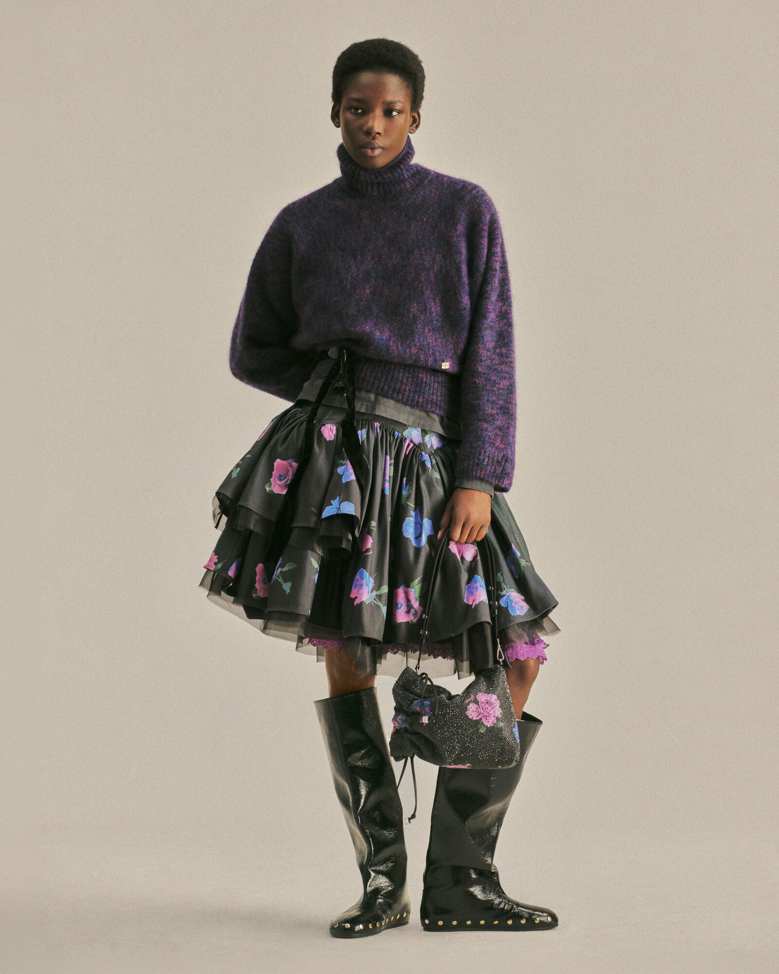 Purple GANNI knit worn over a tiered black floral skirt