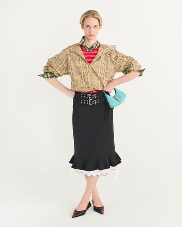Model wearing a snake printed shirt and black skirt
