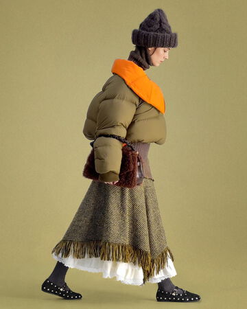 Model wearing green puffer and Mary-Jenny Moccasins