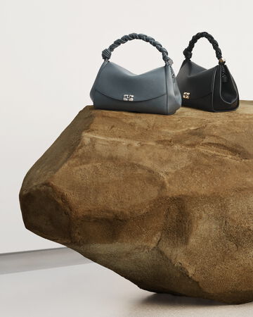 Handbags displayed on a stone platform