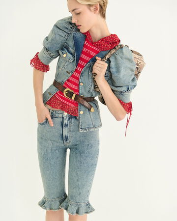 Model wearing a blue puff-sleeve denim top with matching shorts