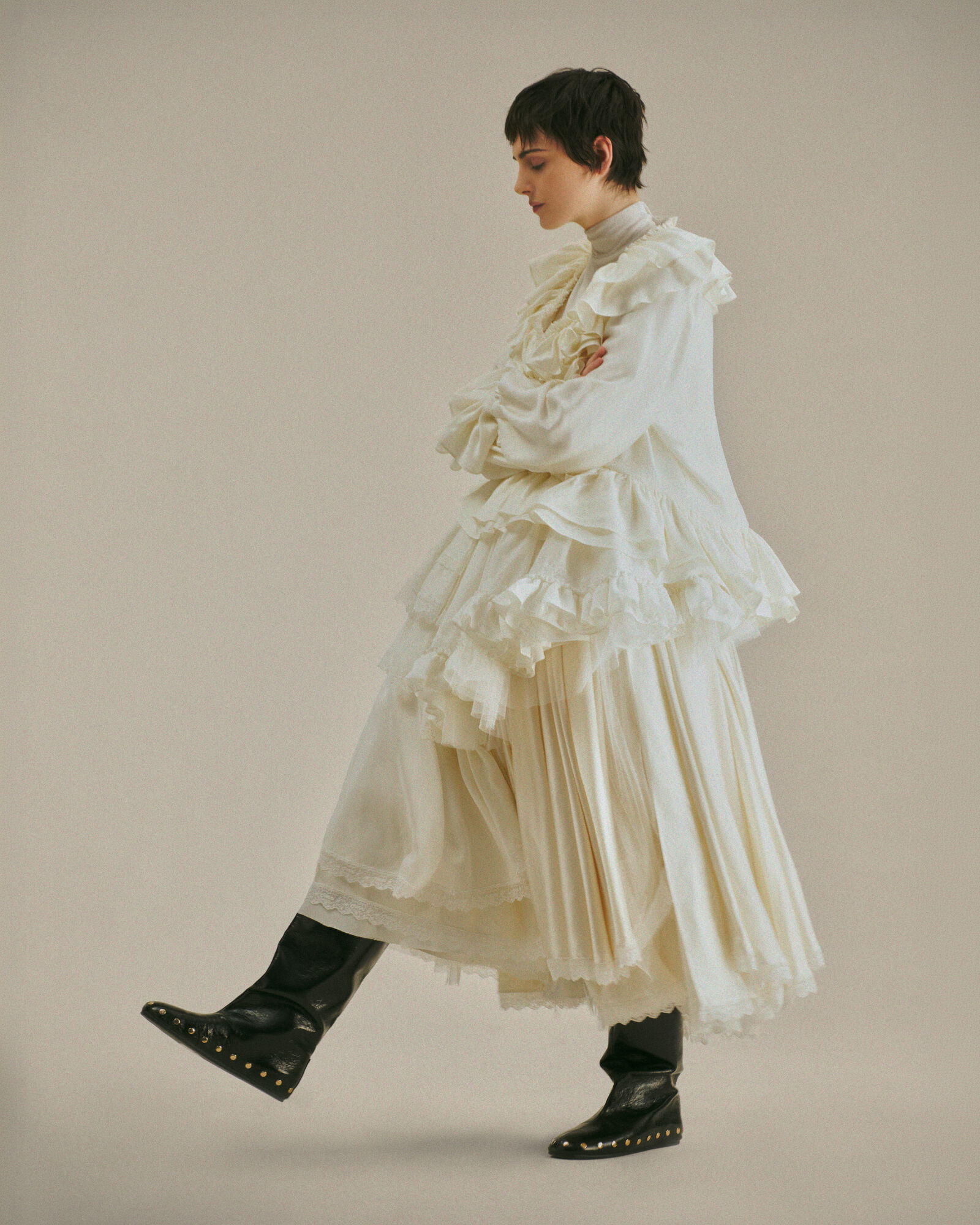 All-white GANNI dress built from layered ruffles and lace